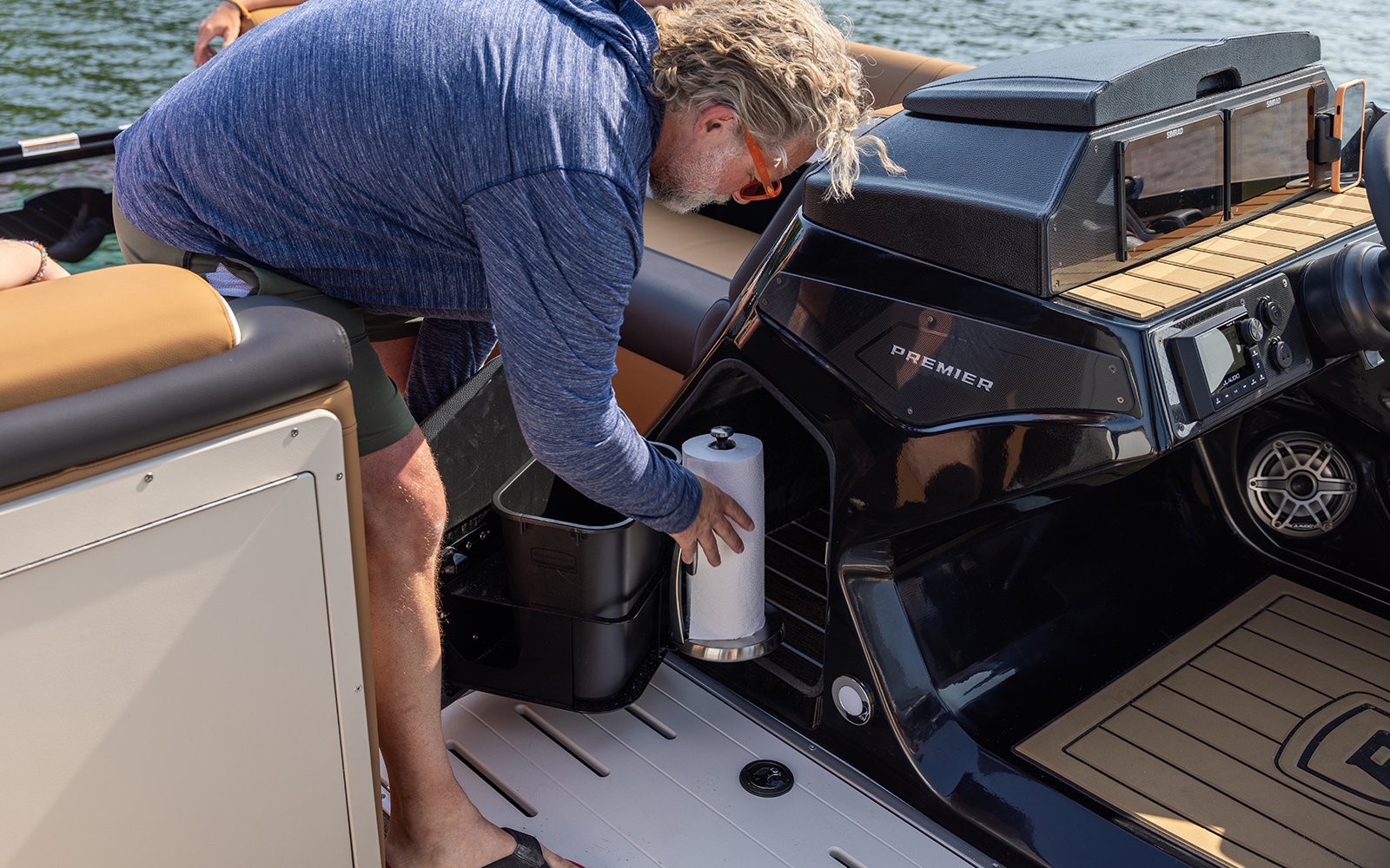 Helm storage with trash can and paper towel holder